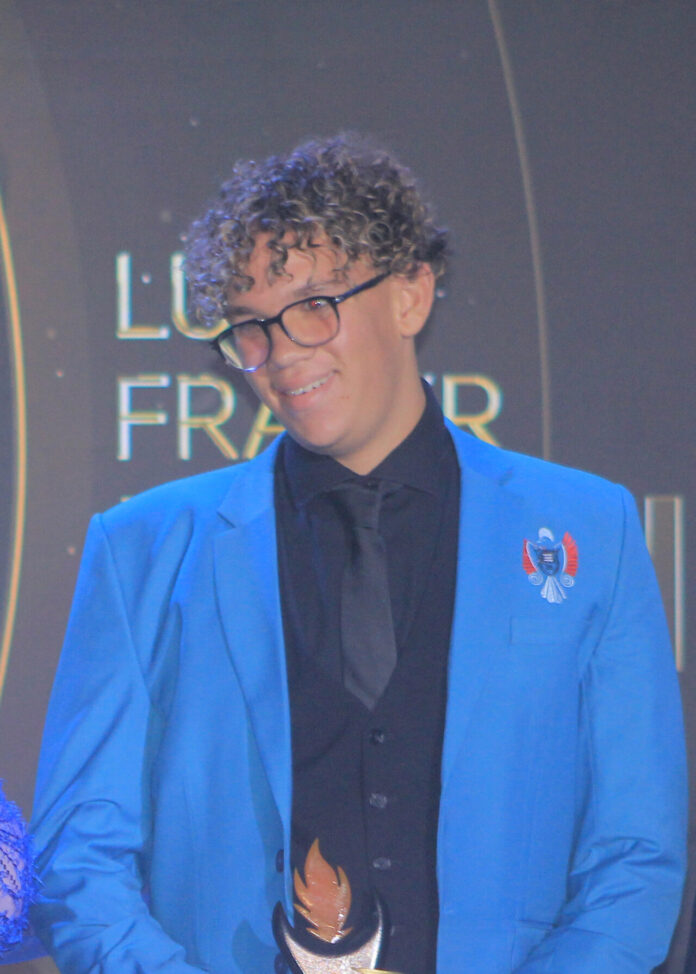 Luca Fraser recieving his award from EOGCA Board Member Pearl Dlamini.