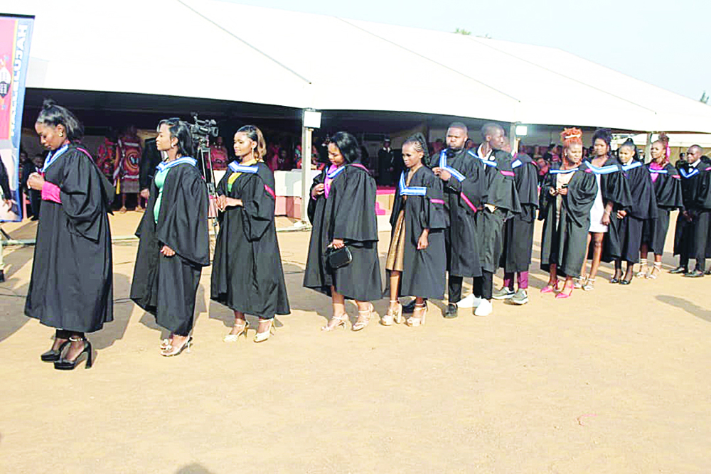 Graduands queue as they get ready to be conferred with their diplomas.