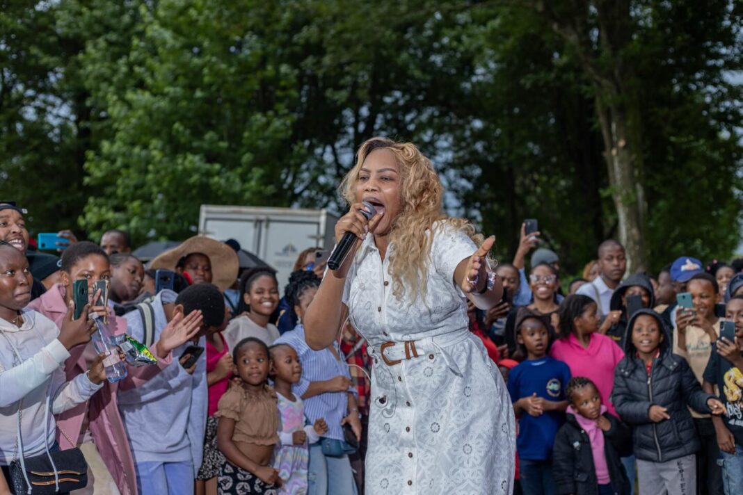 Nothando Hlophe dancing along with attendees as the band entertains the crowd.