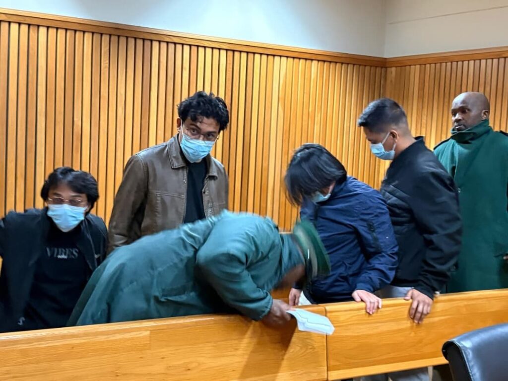 Filipino nationals accused in an online gambling scam have applied for bail, citing harsh prison conditions, while the Crown opposes their release.